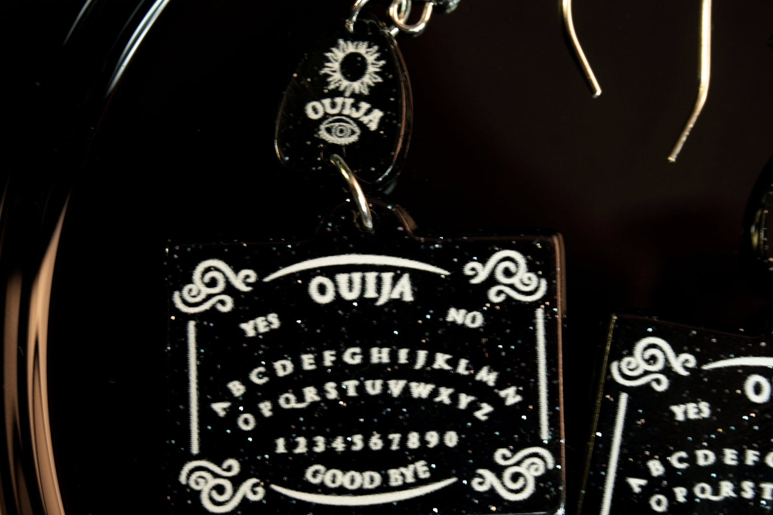 closeup of ouija board earrings