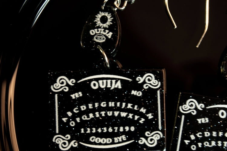 closeup of ouija board earrings