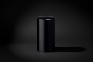Black candle on a white background