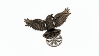 Bronze eagle emblem with outstretched wings on a white background