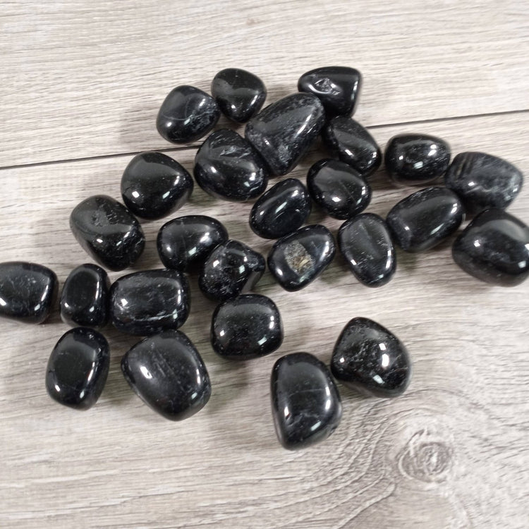 Black stones on a wooden surface