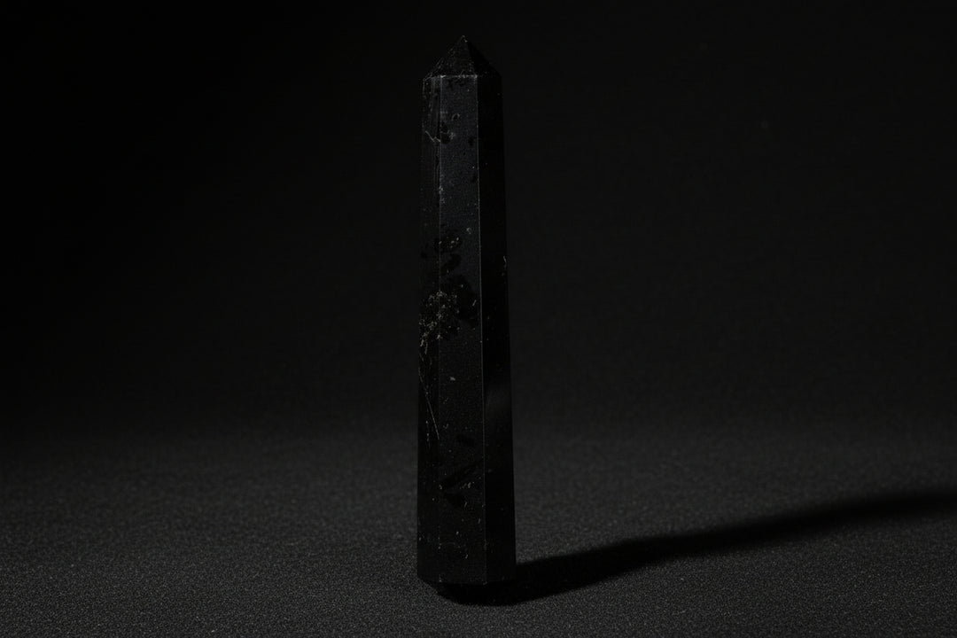 Double-terminated black tourmaline wand held in hand