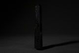 Double-terminated black tourmaline wand held in hand