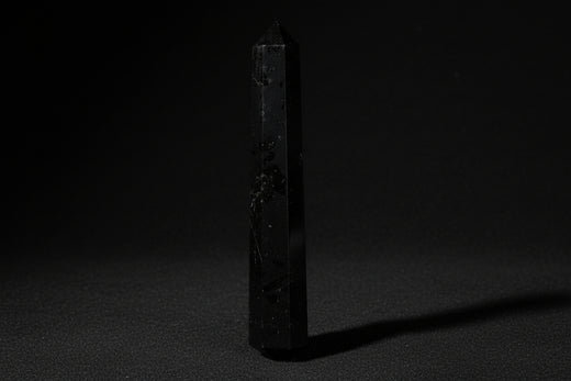 Double-terminated black tourmaline wand held in hand