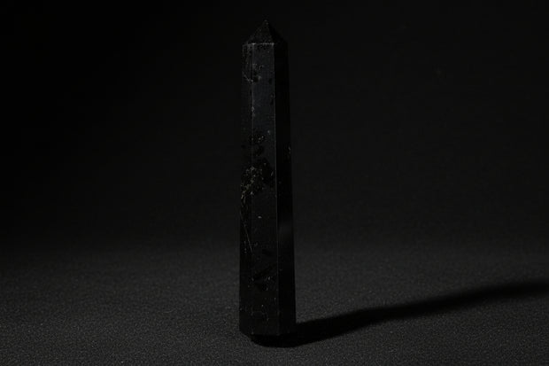 Double-terminated black tourmaline wand held in hand