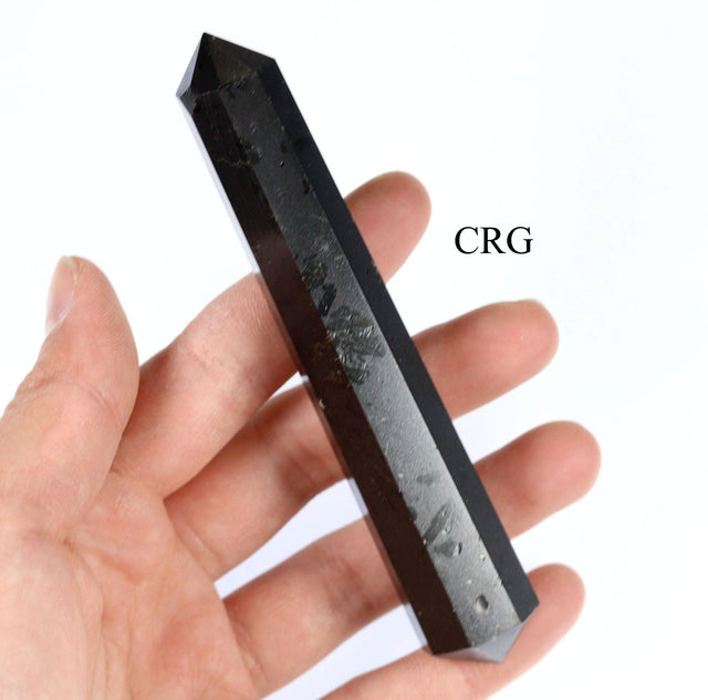 Black crystal held in a hand with 'CRG' branding.