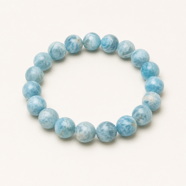 Representative stretch bracelet sold as Blue Aragonite with polished pale-blue and white beads; color, clouding, treatment, bead size, and fit vary