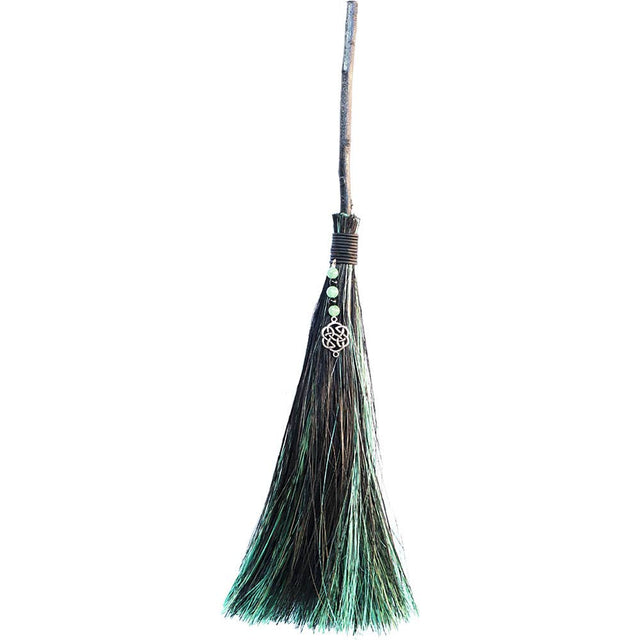 Broom with green bristles on a white background