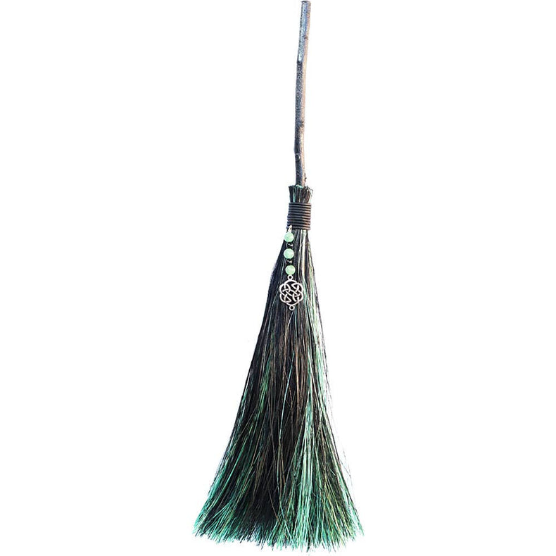 Broom with green bristles on a white background