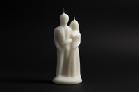 White candle shaped like a couple on a white background