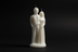 White candle shaped like a couple on a white background