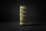 Bundle of sage tied with white string on a white background