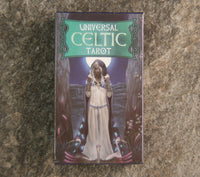 A 78-card tarot deck with a Celtic theme, featuring a character in a white robe against a mystical background, titled 'Universal Celtic Tarot'.