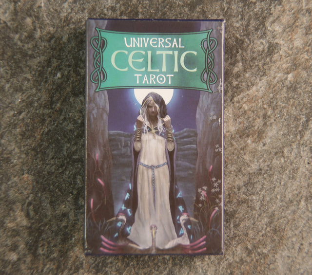 A 78-card tarot deck with a Celtic theme, featuring a character in a white robe against a mystical background, titled 'Universal Celtic Tarot'.