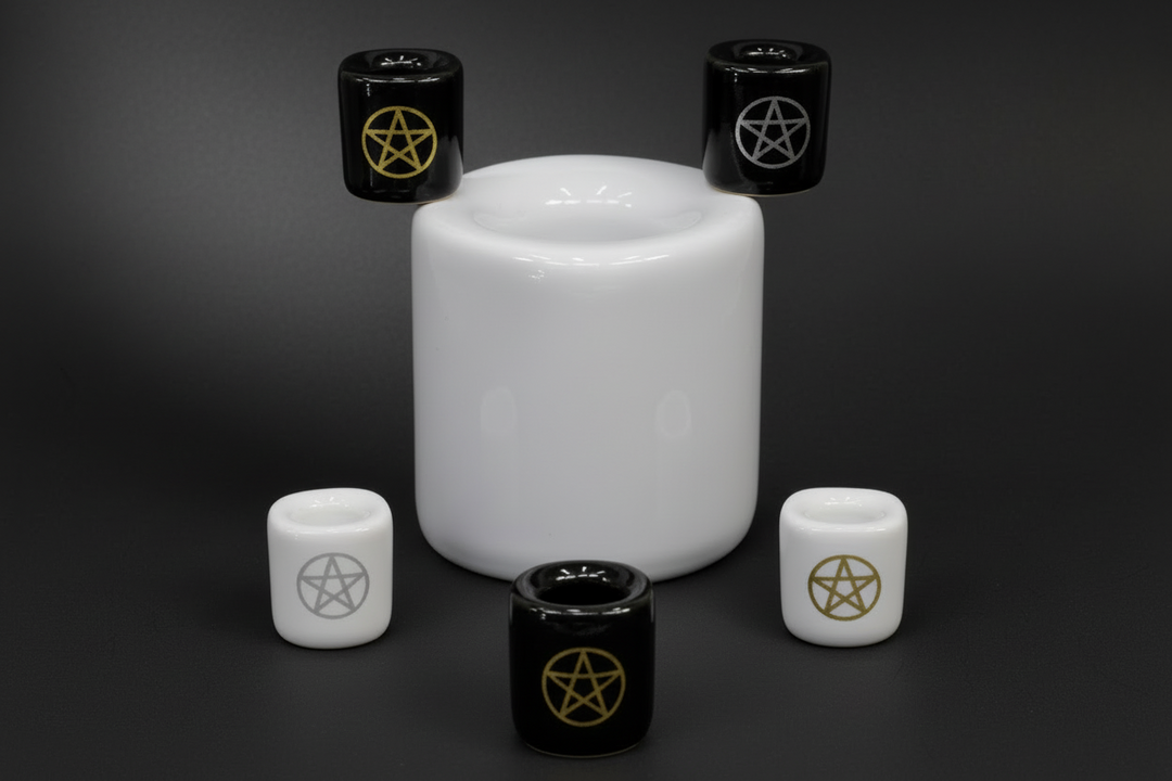 a selection of chime candle holders, some plain some with pentacles