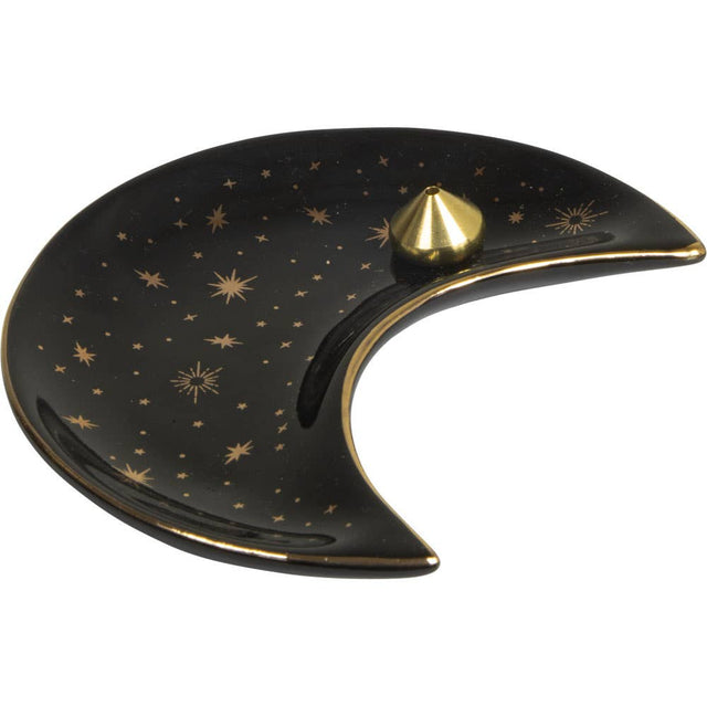 Black ceramic dish shaped like a crescent moon with gold stars and a gold knob on a white background