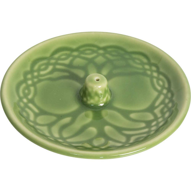 Green ceramic incense burner with decorative design on a white background
