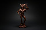 Brown figurine of a muscular man with horns on a white background