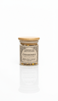Jar of chamomile flowers with a wooden lid on a white background