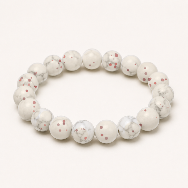 Representative beaded bracelet sold as Chicken Blood Stone with polished cream, gray, and deep red markings; composition, cinnabar content, variant, treatment, and fit vary