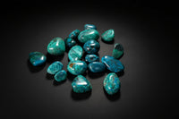 Polished blue-green Chrysocolla tumbled stones with dark matrix