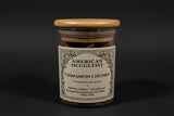 Jar of dried cinnamon bark chunks (Cinnamomum verum) with a wooden lid.