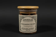 Jar of dried cinnamon bark chunks (Cinnamomum verum) with a wooden lid.
