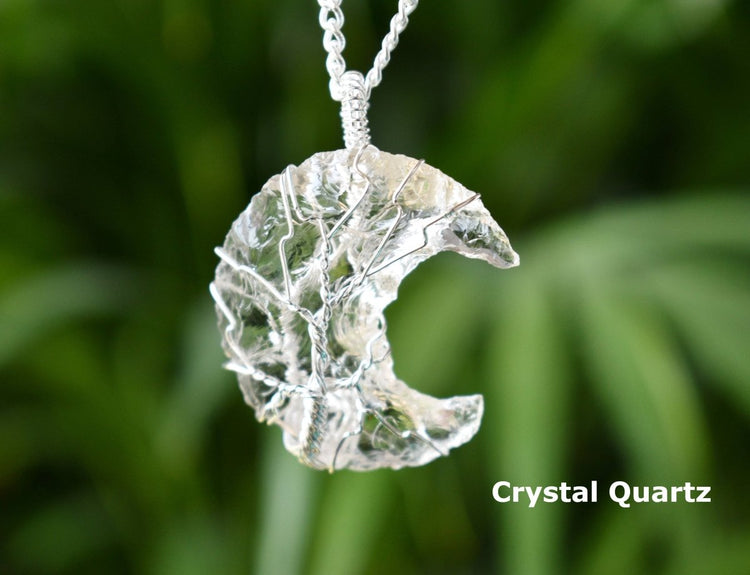 Crystal Quartz necklace against a blurred green background