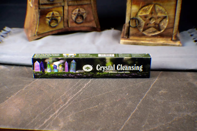 Box of Crystal Cleansing incense sticks on a wooden surface with a mystical background.
