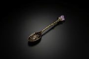 Gold-tone decorative altar spoon with purple cluster-style topper