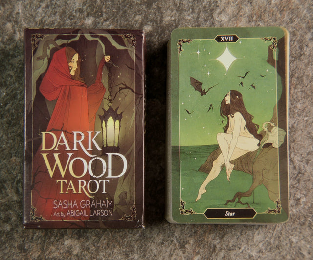 The image shows a 78-card Dark Wood Tarot Deck with a red and black card box, and one card displayed featuring a white figure on a horse.