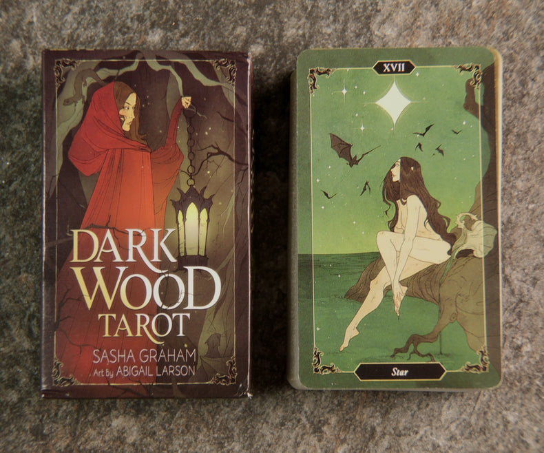 The image shows a 78-card Dark Wood Tarot Deck with a red and black card box, and one card displayed featuring a white figure on a horse.