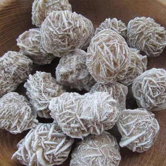 Frosted spherical selenite clusters on a wooden surface