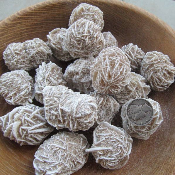 Wooden bowl filled with spherical clusters on a light background