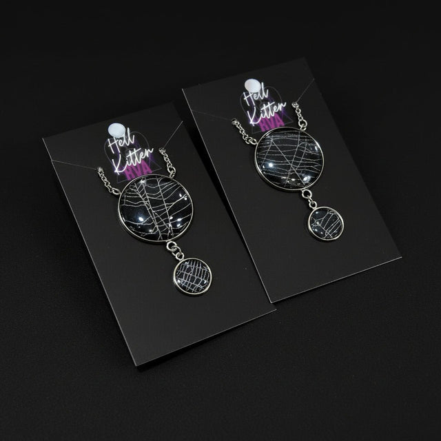Double moon necklace containing real spiderweb