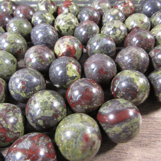 Close-up of marbled dragons blood gemstones on a wooden surface