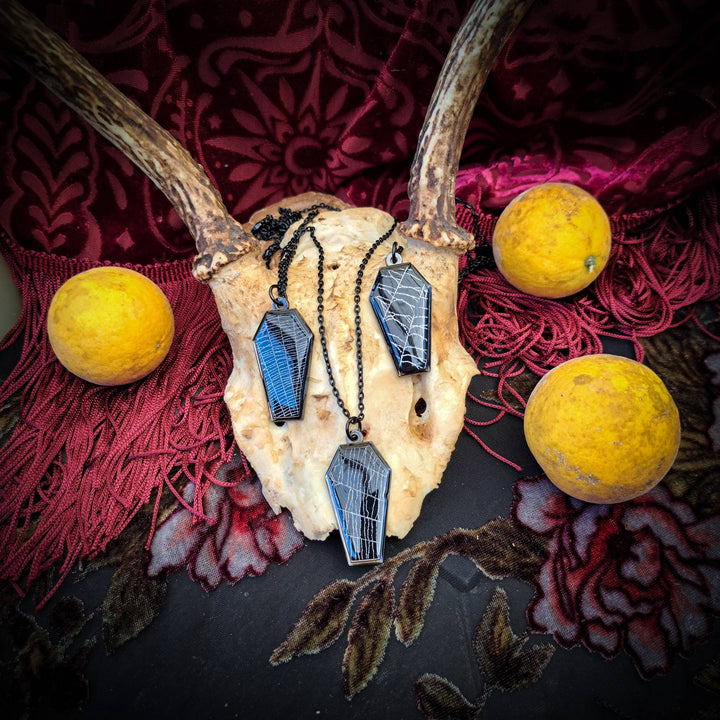 Alternate view of black coffin necklace containing real spiderweb