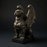 Seated winged lion gargoyle statue with a dark finish