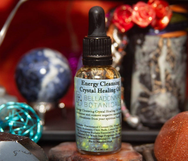 Bottle of Energy Cleansing Crystal Healing Oil with a dropper on a mystical background.