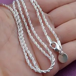 .925 Silver rope chain necklace with a round pendant on a hand.
