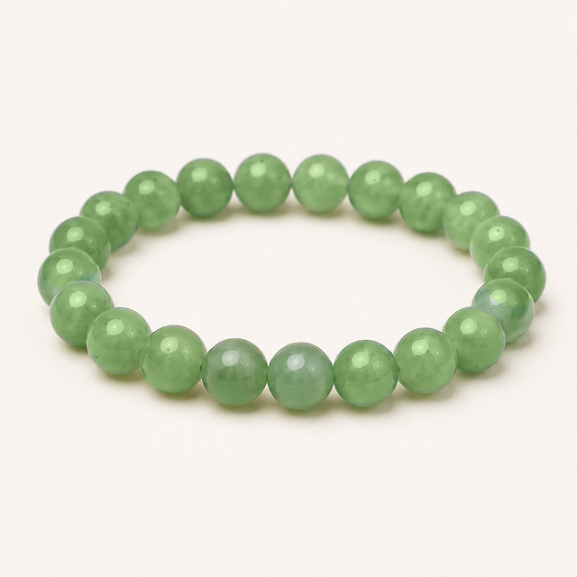Faceted prehnite beaded stretch bracelet with pale translucent green beads and dark natural inclusions.