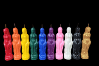 Colorful body-shaped candles arranged in a row on a black background