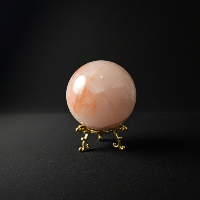 Polished pink Fiery Rose Quartz sphere with internal veils and inclusions