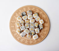 Set of runes on stone dice with a wooden board featuring runic designs.