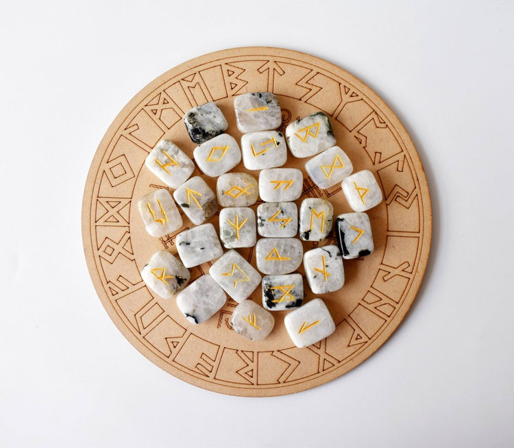 Set of runes on stone dice with a wooden board featuring runic designs.
