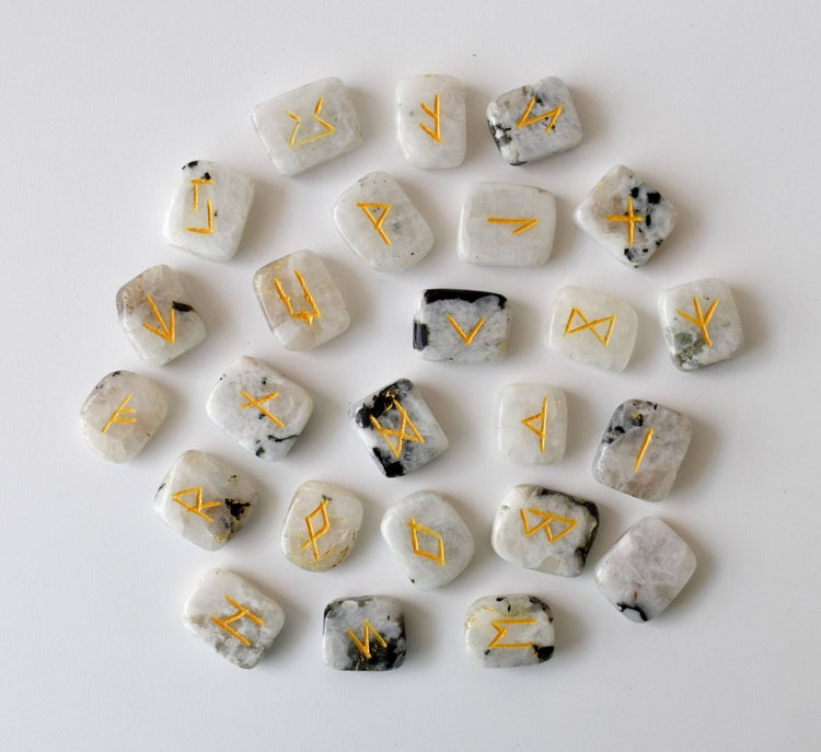 Set of stones with gold runes on a white background