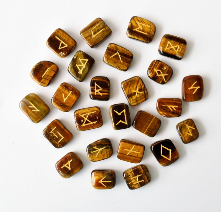 Set of tiger eye runes with gold symbols on a white background