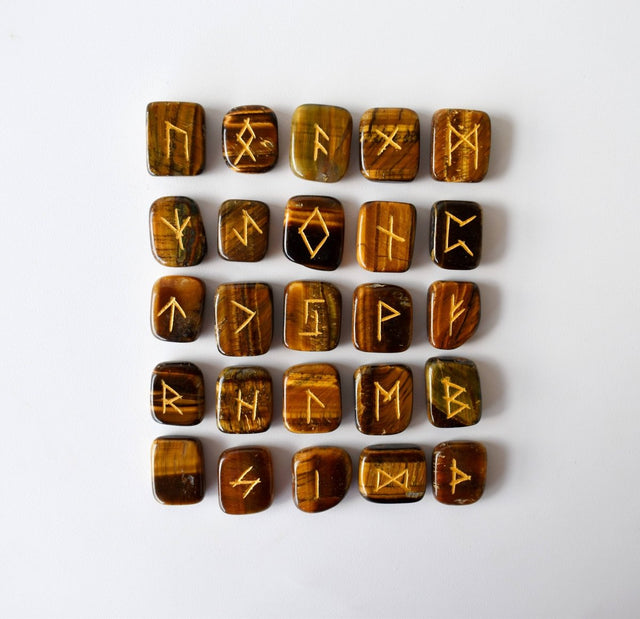 Set of wooden runes with engraved symbols on a white background