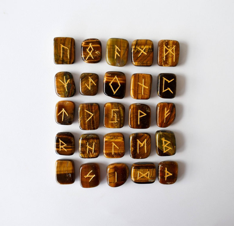 Set of wooden runes with engraved symbols on a white background