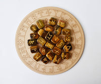 Runic stones on a wooden board with engraved symbols
